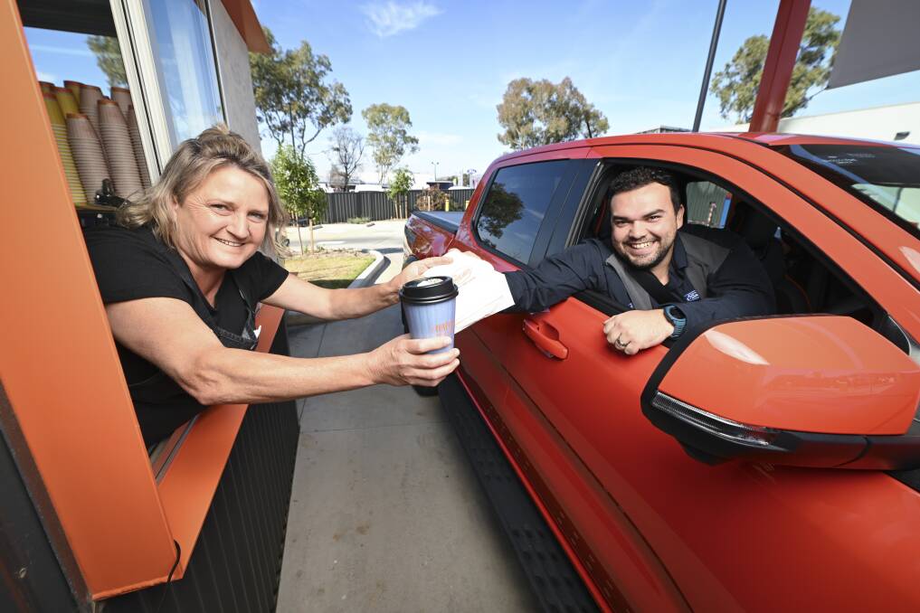 The Fast Lane Drive-Thru Coffee Wodonga manager Susan Hayes greets Blacklocks Ford's Nick Jardim as he collects his beverage. Picture by Mark Jesser