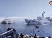 A Chinese ship uses a water cannon on a Philippines vessel at Scarborough Shoal (file pic). (AP PHOTO)